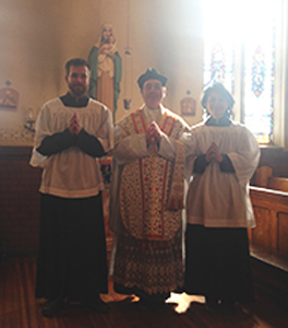 Servers and celebrant in the church