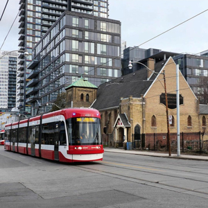 Exterior view of church with streetcar passing